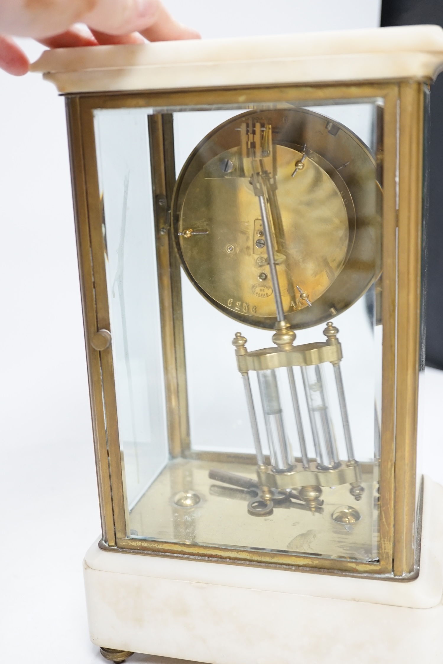 A French lacquered brass and marble, enamelled dial, four glass mantel clock, 30cm high